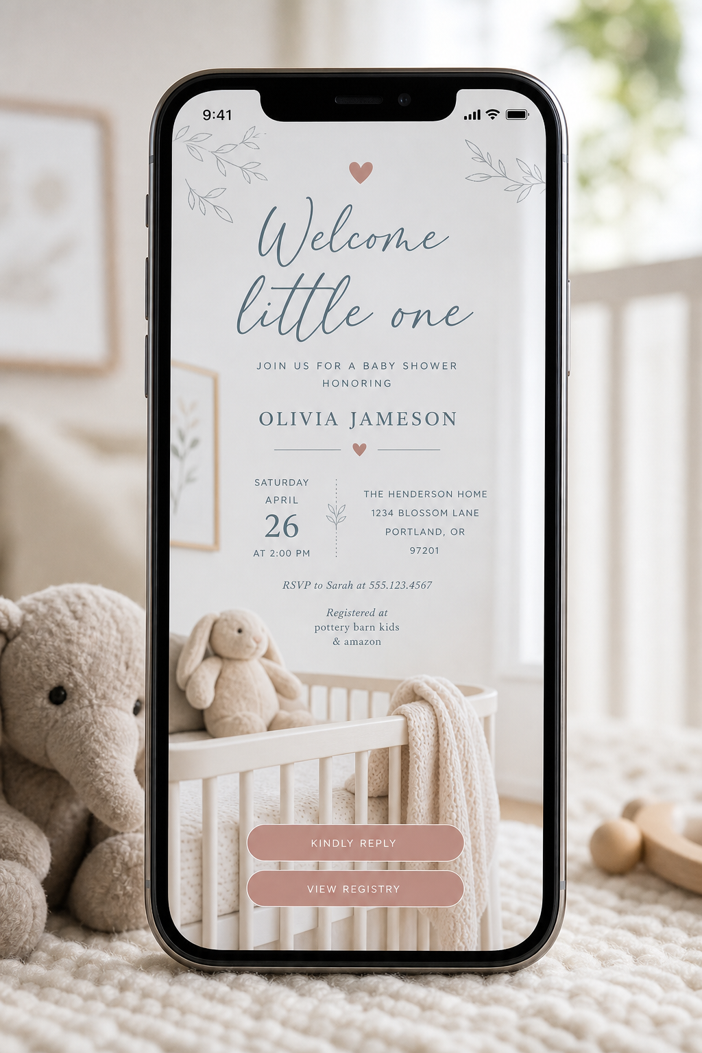 Phone showing a soft baby shower invite in a nursery setting
